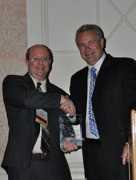 FMDA- Oct. 2011 147.jpg - FMDA Executive Director Ian Cordes (left) is presented with an award by past-president Dr. Hugh Thomas (right) for his many years of service to FMDA.